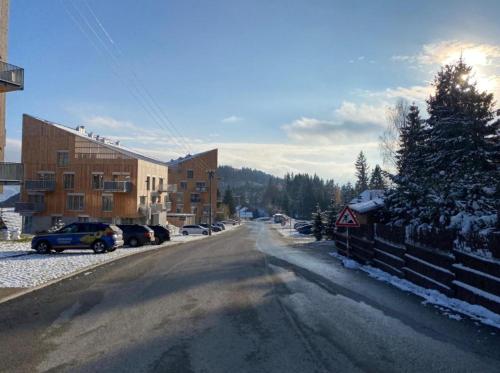 a street with cars parked on the side of the road at PanorámaX12 Hillside apartmán in Dolný Kubín