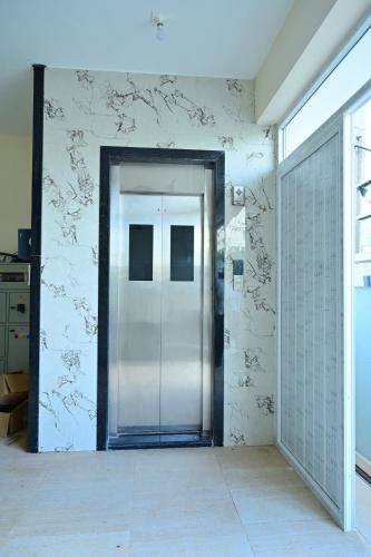 a hallway with a glass door in a building at Vaarahi Guest Inn in Nellore