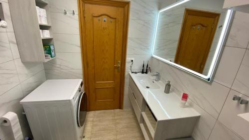 a bathroom with a sink and a washing machine at Ocean View Apartament in Los Cristianos