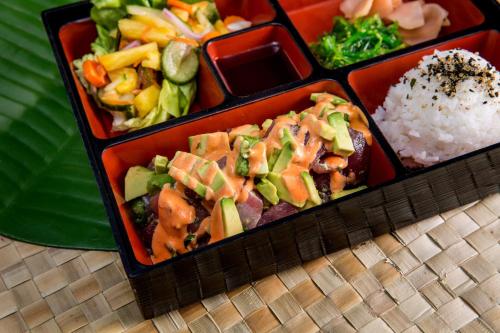 a tray of food with vegetables and rice on a table at Sheraton Kauai Resort in Koloa