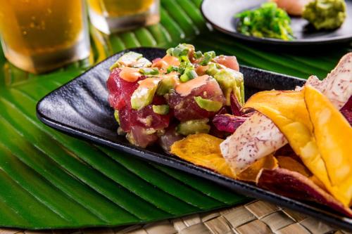 a black plate of food on a green table at Sheraton Kauai Resort in Koloa