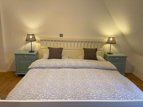 a bedroom with a large bed with two night stands at Ferienhaus an der KIostermauer in Speyer