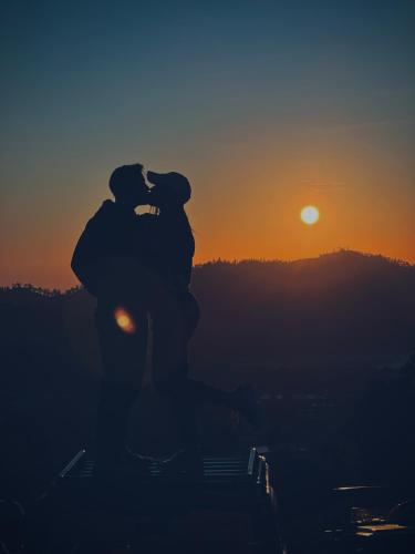 a silhouette of a couple kissing at sunset at Pondok Bulan Lake View in Kintamani