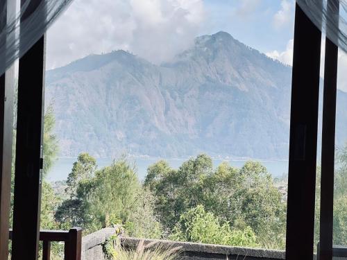 a view of a mountain from a window at Pondok Bulan Lake View in Kintamani