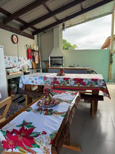 a kitchen with a table with a table cloth on it at Suite 3- Praia bonita Hospedagem,agora com ar condicionado in São Francisco do Sul