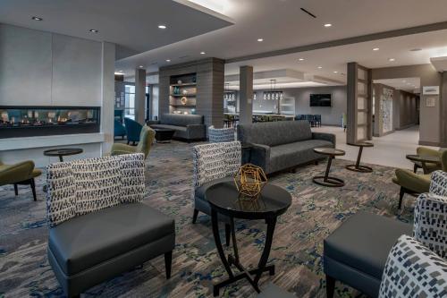 a lobby with couches and chairs and a fireplace at TownePlace Suites By Marriott Wrentham Plainville in Wrentham