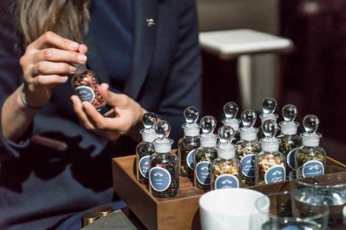 a person is holding a bottle of perfume at The St. Regis Toronto in Toronto