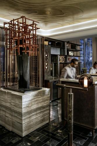 a kitchen with a chef working in a restaurant at The St. Regis Toronto in Toronto