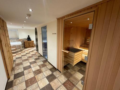 a room with a bathroom with a sink and a tub at Appartements Olympia in Mayrhofen
