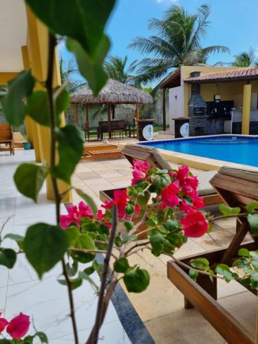 a view of a swimming pool with pink flowers at Casa Ferreira Cumbuco in Caucaia