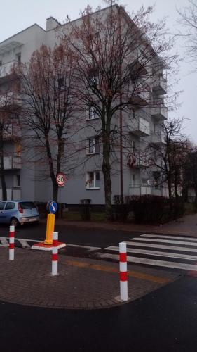 a street with traffic cones and a building in the background at PRADA Apartament Konin in Konin