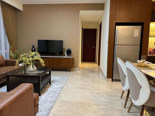a living room with a couch and a television at Two Bedrooms, Two Bathrooms, Fully Furnished, Executive Apartment in Jakarta