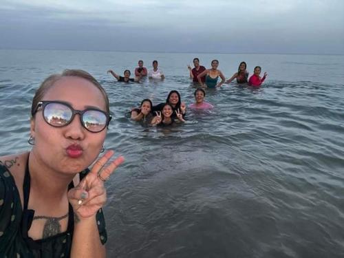 a group of people swimming in the water at Casa Vacanza Talaonga Ocean View Resort -Viajeros Booking Services in Sorsogon