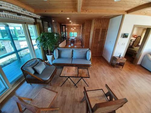 a living room with a blue couch and chairs at Executive Home in Jeju in Jeju