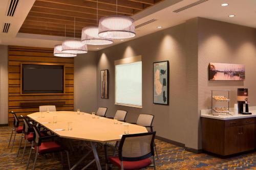 a conference room with a large table and chairs at TownePlace Suites by Marriott Foley at OWA in Foley