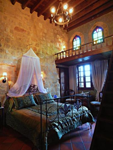a bedroom with a bed in a stone walled room at S.Nikolis' Historic Boutique Hotel in Rhodes Town