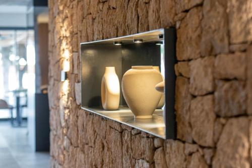 two vases are on display in a brick wall at Ayvalık Sea Long in Ayvalık
