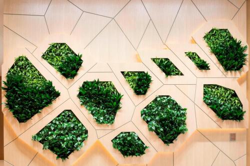 a bunch of green plants on a wall at The Westin Jackson in Jackson