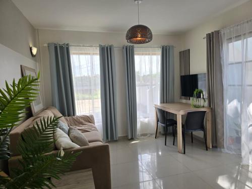 a living room with a couch and a table at Bubali Residence in Palm-Eagle Beach