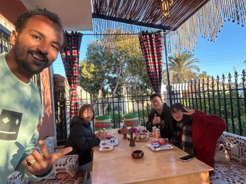 a group of people sitting around a wooden table at Karma Kono in Abu Simbel