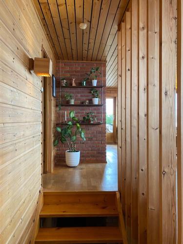 a room with a brick wall and a plant at 1960's Architect Villa with Stunning Views in Trondheim