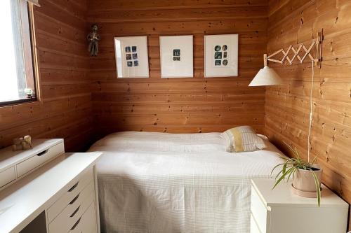 a bedroom with a bed in a wooden wall at 1960's Architect Villa with Stunning Views in Trondheim
