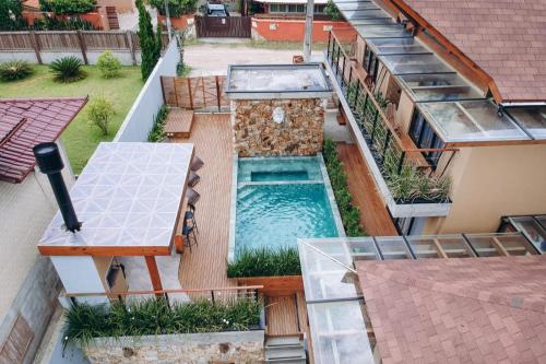 an aerial view of a house with a swimming pool at Pousada Kirana in Praia do Rosa