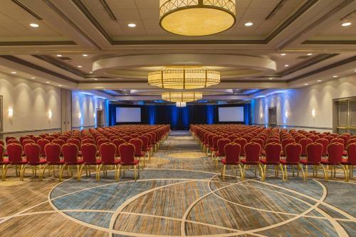 a conference room with red chairs and a stage at Baltimore Marriott Inner Harbor at Camden Yards in Baltimore