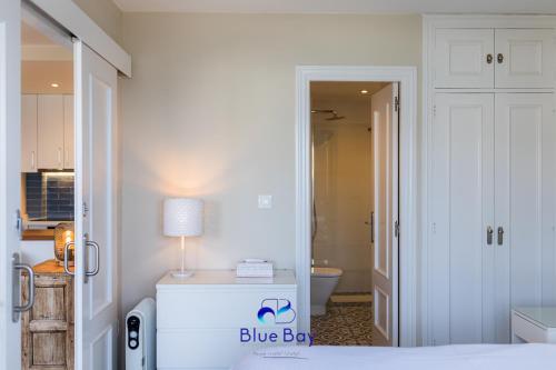 a bedroom with a blue box sign on a bed at Bliss On The Bay Apartment in La Herradura