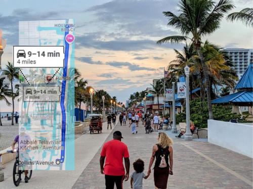 a group of people walking down a street at Stunning Water Views 1BR Condo with Pool and Tennis Court in Sunny Isles Beach