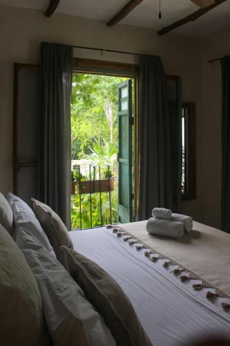 a bedroom with a bed with two towels on it at VerdeAmar Eco Lodge Jungle Retreat in Chemuyil