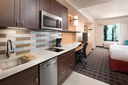 a kitchen with a sink and a desk in a room at TownePlace Suites by Marriott San Diego Downtown in San Diego