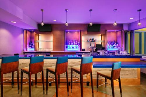 a bar with blue chairs and purple lighting at TownePlace Suites by Marriott San Diego Downtown in San Diego