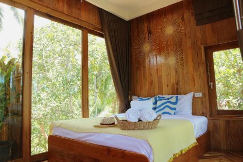 a bedroom with two beds with hats on them at บ้านพราวพร้าว Baan Proud Proud in Khanom