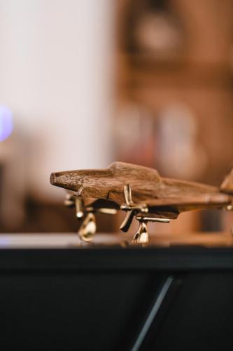 a wooden toy airplane sitting on top of a table at Kepler Club Riga Airport Hotel - Landside Public Area in Rīga