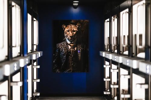 a painting of a tiger on a blue wall at Kepler Club Riga Airport Hotel - Landside Public Area in Rīga