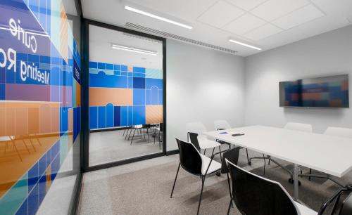 a conference room with a white table and chairs at Kepler Club Riga Airport Hotel - Landside Public Area in Rīga