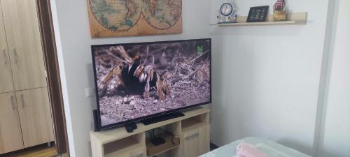 a flat screen tv sitting on a stand in a room at Mavrov02 Residence in Mavrovo