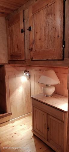 a kitchen with wooden cabinets and a counter top at La Grand'Raie Table d'hôtes in Les Gras
