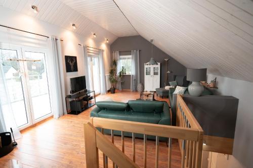 a living room with a couch and a table at Ferienhaus Glücklich am Harz in Goslar