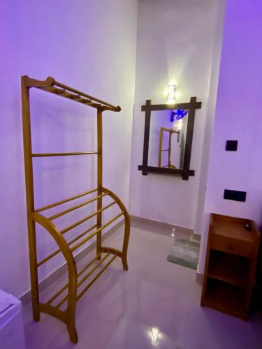 a room with a towel rack and a mirror at Cozy Homestay Waterfall Road Ella in Ella
