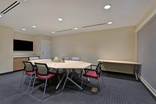 a conference room with a table and chairs and a screen at TownePlace Suites by Marriott El Paso East/I-10 in El Paso