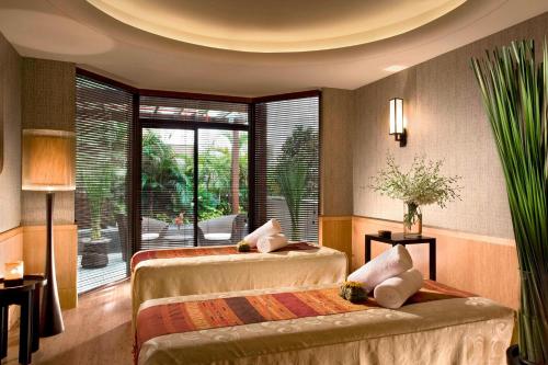 a bedroom with two beds and a large window at Sheraton Towers Singapore Hotel in Singapore