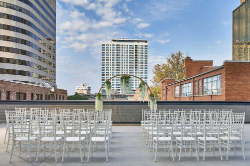 a row of white chairs sitting on top of a roof at Le Méridien St. Louis Clayton in Clayton