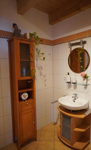 a bathroom with a sink and a mirror at FeWo BergZeit auf 1000 m Höhe mit Balkon, Parkplatz, WLAN, Küche in Wertach