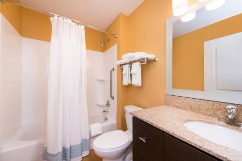 a bathroom with a white toilet and a sink at TownePlace Suites Huntington in Huntington