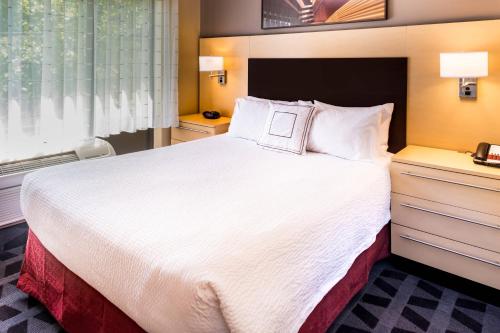 a hotel room with a large bed and a window at TownePlace Suites Huntington in Huntington