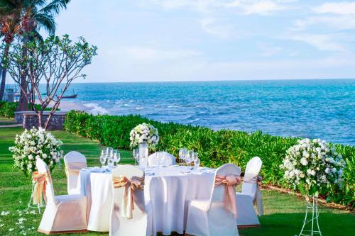a table set up for a wedding by the ocean at Sheraton Hua Hin Resort & Spa in Cha Am