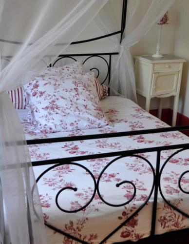 a bedroom with a bed with a canopy at Château De Matel in Roanne