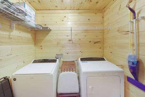 a small cabin with two washing machines in it at Enchanted Forest Cabin And Teepee! Lights & Laser Show! Private Hot Tub! Unique Stay! in Sevierville